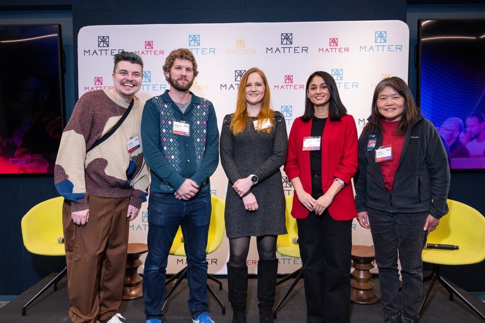 Five Chicago tech leaders smiling on stage for a panel discussion